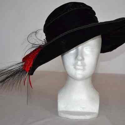 Velvet wide brim hat with red and black feathers and silver pins