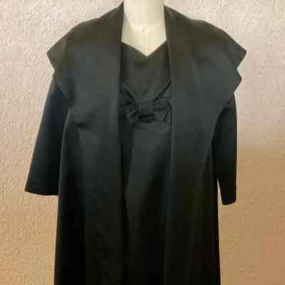 Satin open front wide collar 3/4 jacket with v-neck cap sleeve sheath with empire waist, front bow detail.
