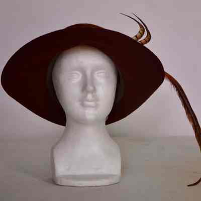 Wool felt hat with fold up brim and feather trim
