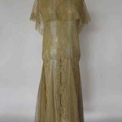 Sleeveless dress with embroidered netting panels, collar and embroidered panels, godets on skirt