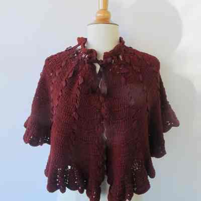 Crocheted capelet with threaded ribbons