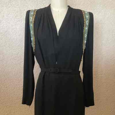 Long sleeve floor length V-neck crepe dress with tunic layer, beaded trim on tunic skirt and at armholes, self belt