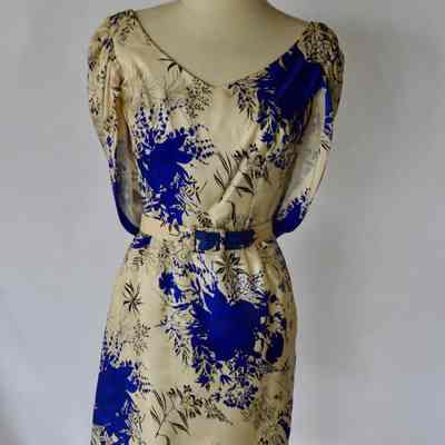 Floral print sleeveless dress with caped shoulders and self belt