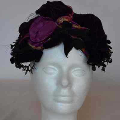 Casque with sequins and beading trim, velvet bows, and multi velvet poufs, small feather