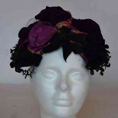 Casque with sequins and beading trim, velvet bows, and multi velvet poufs, small feather