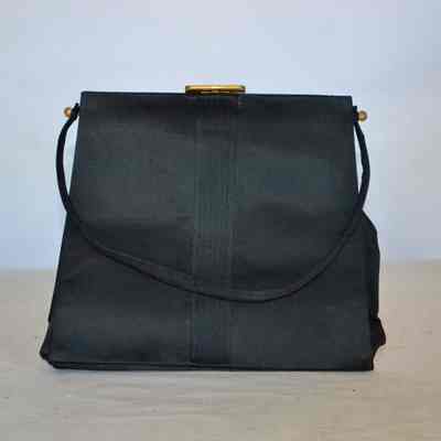 Structured fabric bag with pleated embellishment, self handle, brass clasp