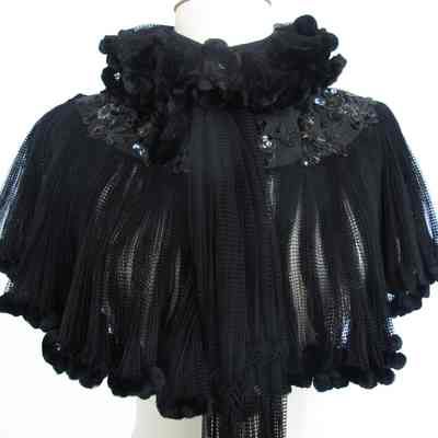 Mesh cape with chenille trim and sequin embellishment on yoke