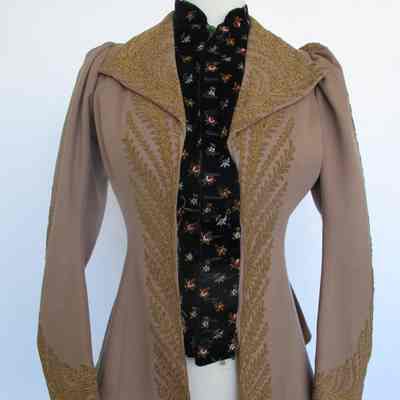 Tan long sleeve short jacket with embroidered velvet panel and couched embroidery