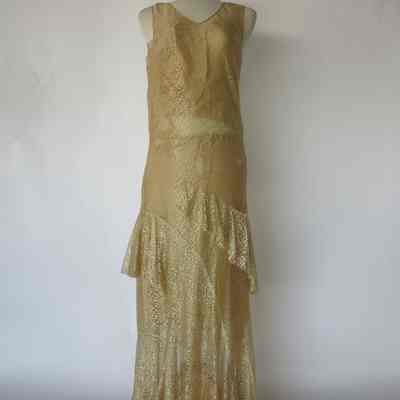 Long sleeve lace jacket with closure at peplum and sleeveless v-neck long flounced lace dress