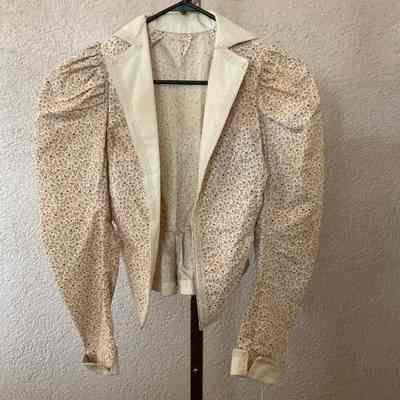 Floral jacket, leg o'mutton sleeves, large contrast notched collar and lapel, and sleeve cuffs, trim on lapels and cuffs