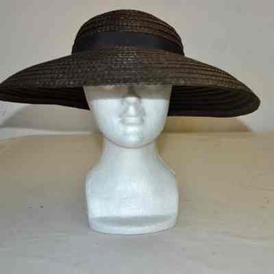 Black straw hat with wide turned down brim, rounded crown and black hatband