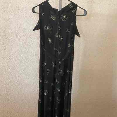 Long sleeveless black dress with gold print, V-neck, front pointed collar, back self tie