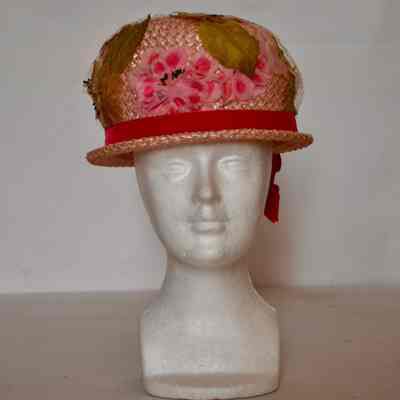 Straw bubble hat with narrow brim, crown covered with floweres and Russian veiling, pink velvet hat band.
