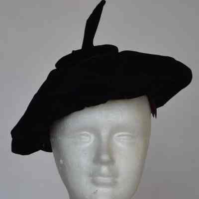Velvet beret with long stem at center of crown