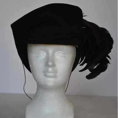Felt hat with narrow front brim, high crown with large feathers at left side