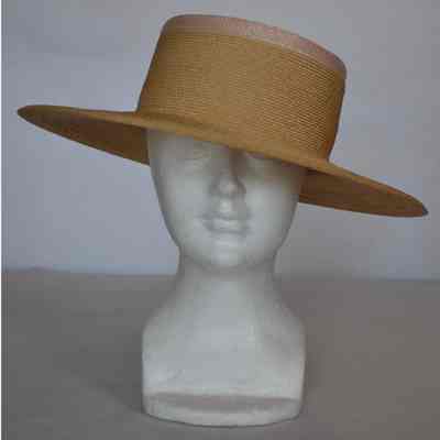 Straw boater style hat with tall crown and light pink trim around top edge of crown