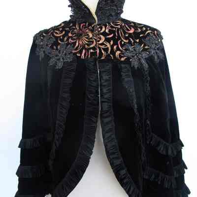 Velvet cape with pleated ribbon trim, beaded embellishment with burnout floral pattern and high stand up collar