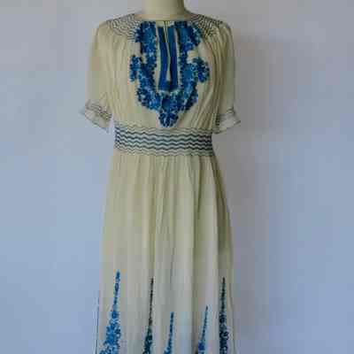 Peasant style dress with smocked waist, embroidered bodice and hem
