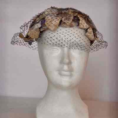 Casque covered in velvet flowers and leaves with netting