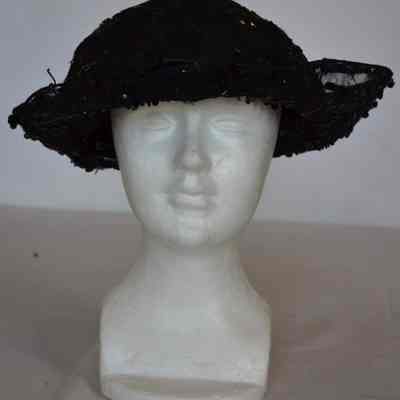 Sequin and beaded netting hat with turned up brim extending to a point in the back, embellished with a bow