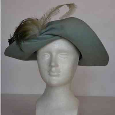 Felt twist front brim hat with green feathers