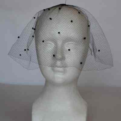 Short full net veil with small pom poms on front