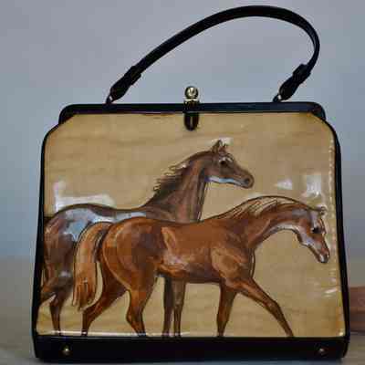 Rigid bag with stitched equestrian design on tan ground,