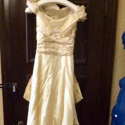 Cream wedding dress with train and off the shoulder draping