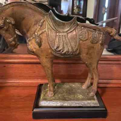 Small horse sculpture with saddle