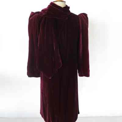 Velvet short evening coat with ornamental stitching on sleeves and attached self fabric neck scarf