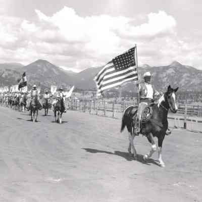 42.: 1955 Estes Park. Grand Parade. Joe Dekker with flag. Photo by "Brack" Brachlow.