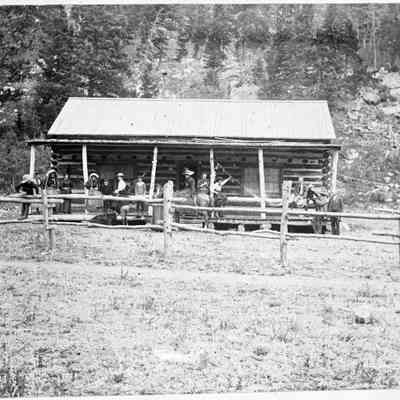 3. Kemp family cabin. Identification on negative envelope: "Kemp cabin 1896. The day's visitors. Group on porch included Grace, May and Elsie Whitmore, Mr. and Mrs Frederick Kruse and family Clara, Ida and Walter. The Kemps incl. the two boys Don and Robert. Summer 1896. Photographer unknown.": Adults and children pose on the porch. A woman sits on a horse and boy plays with a dog in the foreground. Two hammocks are slung from the porch posts.