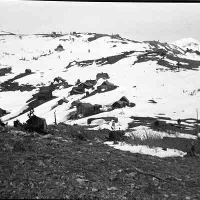 2. View of residential structures and mining structures in the background. Snow on the ground. Number 16 in lower left corner. May be Caribou? 2.5"x4.25" B&W negative. Originally in Foto-Tek envelope, Clint Meier named as customer, date 12/3/86.