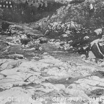 4. After the Cloud-Burst, Sept 7, 1913, Jamestown, Colo: Photo shows creek, man, and building in background. 8.5"x11" print and digital