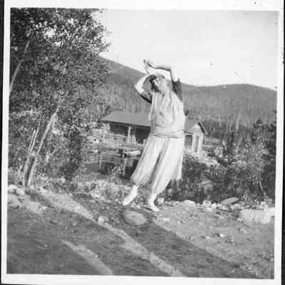 Photo 7: Dancer identified as "Anitra" with lake and one of the Annie Brown lodge buildings in the background