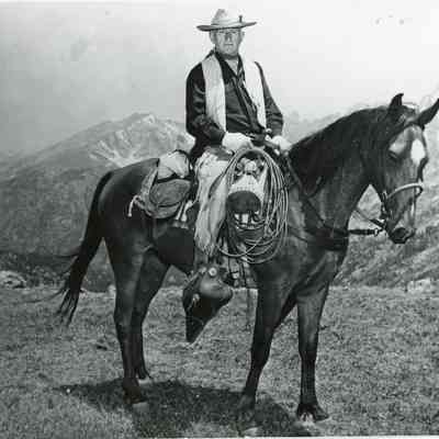 15. Envelope of photos of Don Kemp, trail guide and with horse. "Arapaho Pass, Elv. 2 miles, July 16, 1955": 8 black and white prints (3 of which are duplicates), 2 color prints