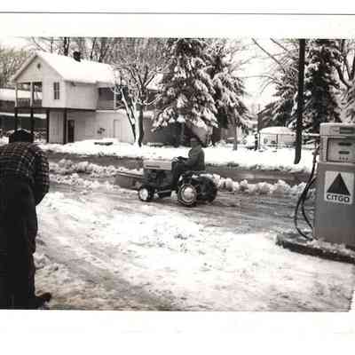 Skeeter Welsh on a mower with a plow in Bakerton, 12-14-1966 "1st snow" written on back: IMG2025.026.001 (43)