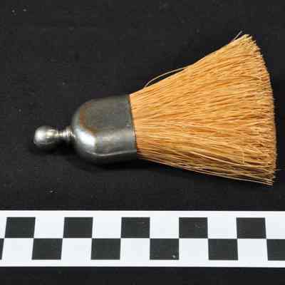 Small brush, possibly for brushing off clothing