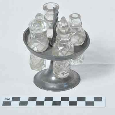 Doll size cruet with four clear glass containers