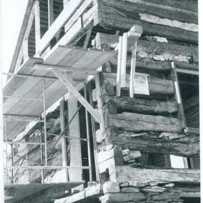 Exterior corner view of farmhouse with exposed wood and stone