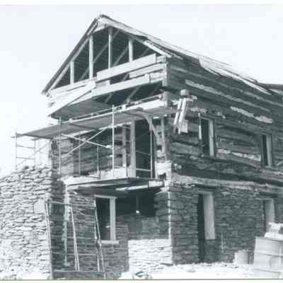 Exterior of farmhouse with exposed wood and stone