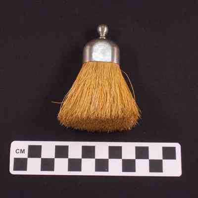 Small brush, possibly for brushing off clothing
