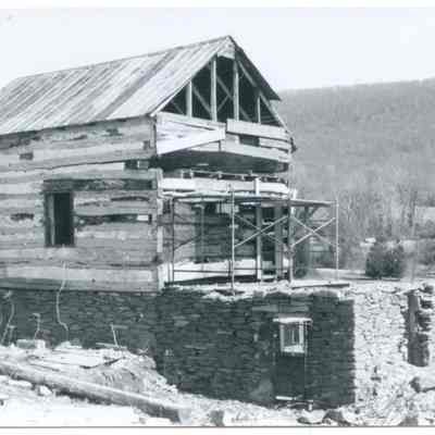 Exterior of farmhouse with exposed wood and stone