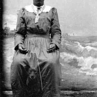 Portrait of a young African American woman with a dog
