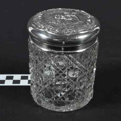 Cut glass container with silver top