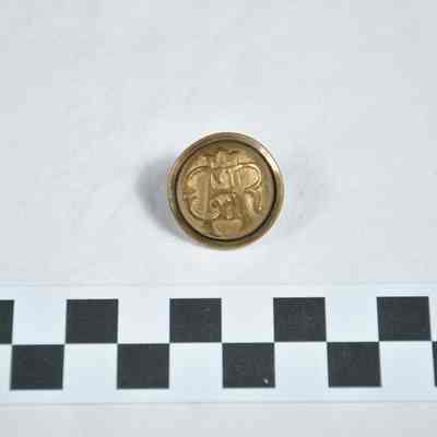 Brass button with the letters "GAR" superimposed