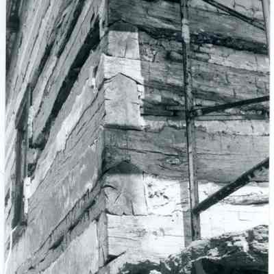 Exterior corner of farmhouse showing exposed wood