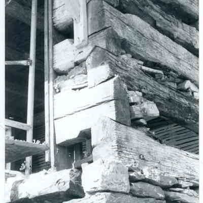 Exterior corner of farmhouse showing exposed wood