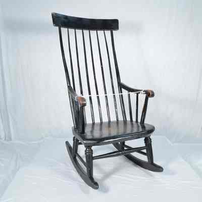 Rocking chair painted brown over black paint