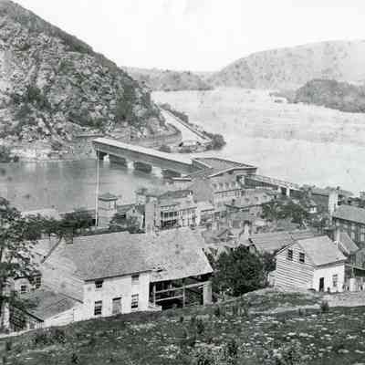 Covered wooden railroad and wagon bridge